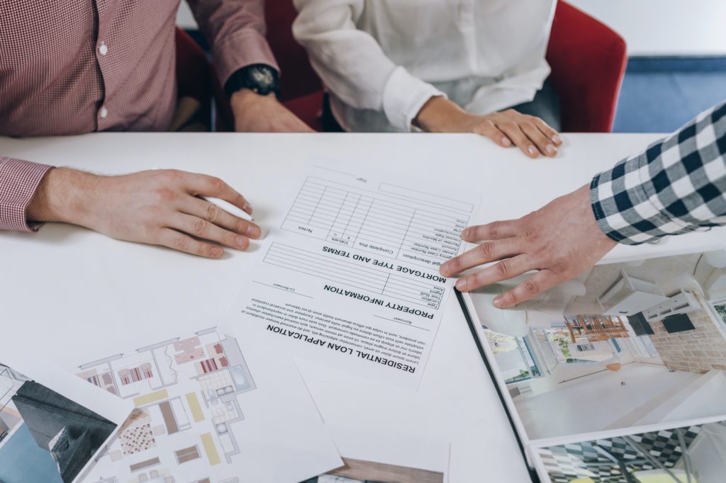 Real Estate Agency. Young Couple Signing Financing Contract