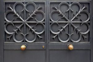 Steel, iron door ancient architectural design. The background of the metal gate