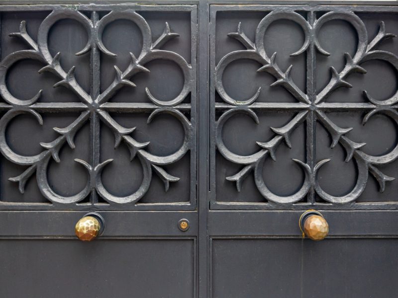Steel, iron door ancient architectural design. The background of the metal gate